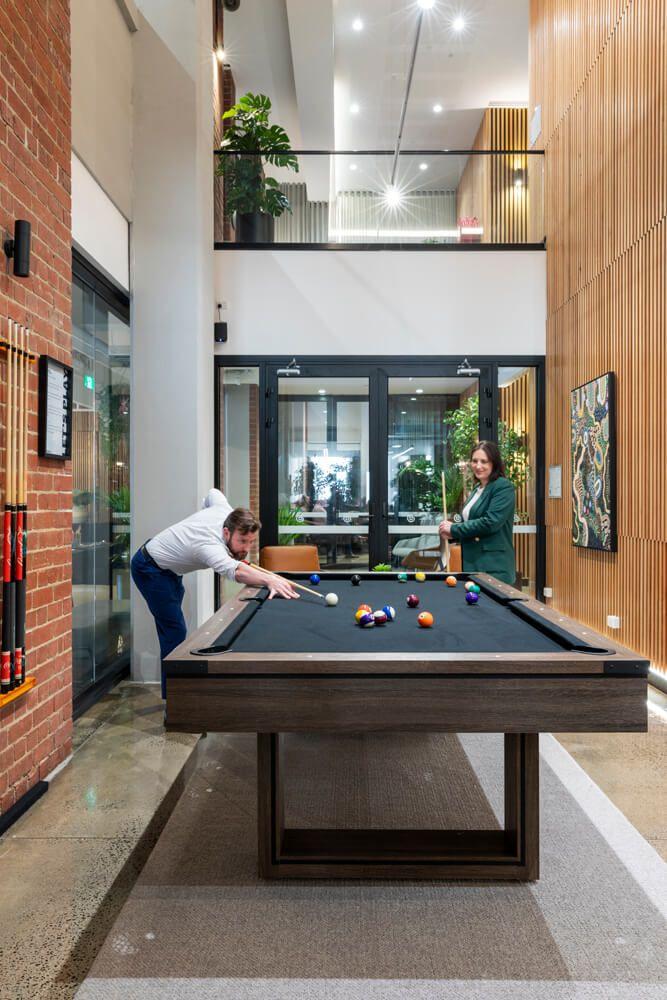 people playing pool in a coworking space