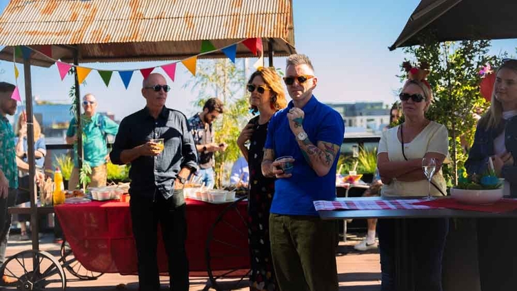 united co members gathering during a community event on the rooftop