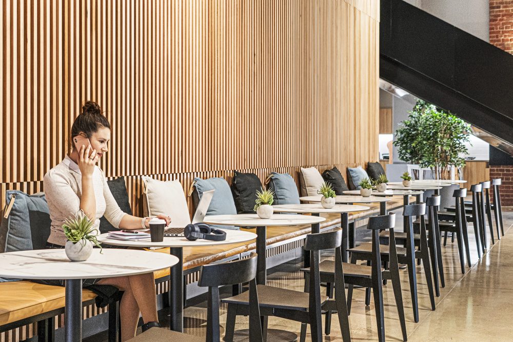 young woman making a phone call in shared work space