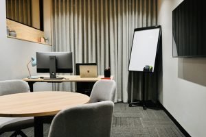 Consulting Room with desk screen and meeting table use whiteboard and tv with screen sharing for client meetings and presentations