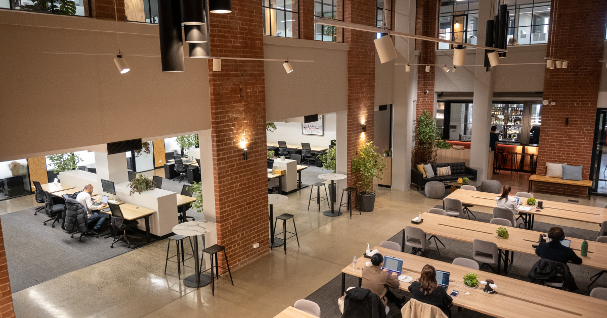 How do coworking spaces impact employee well-being?