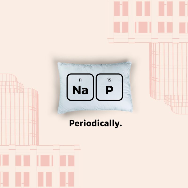 pillow with the word nap written on it wth a drawing of an office building in the background.